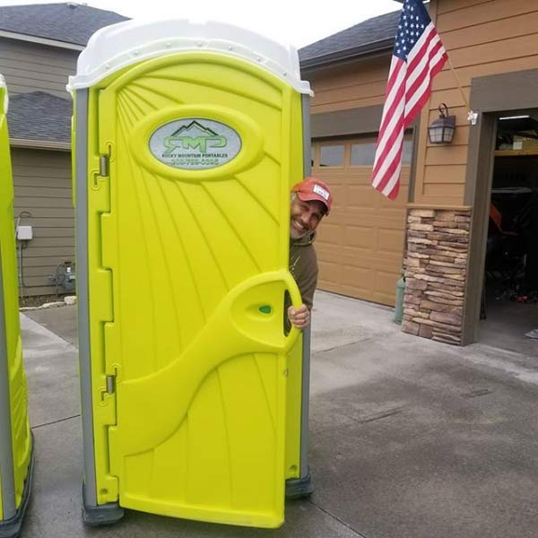Man peeking from portable toilet