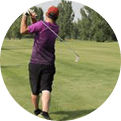 Man playing golf on green course