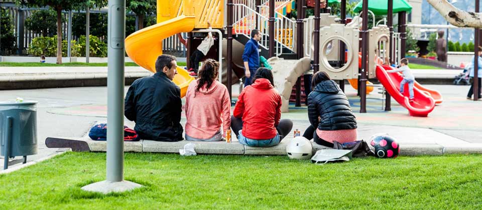Friends relaxing by a playground