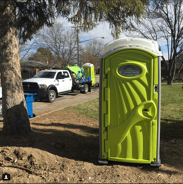 Portable toilet and service truck in park